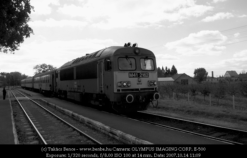 After departing from Tiborszállás the railway goes a bit further from the Kraszna river, then crosses it with a short truss steel bridge. After the bridge is the siding of Rákóczi MGTSZ, named after the Transylvanian monarchs who owned the fortress, built on four islands of the moor, for centuries. The siding is now unused. While the fruit plantations are still there and the processing buildings stand fruits and deep-frozen products are carried by road vehicles. picture