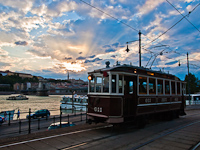 Historic tramcar number 611 of the BKV seen at Budapest Széchenyi tér by sunset with a beautiful Tyndall-phenomenon and the castle of Buda
