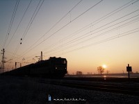 V63 016 with a freight train under the rising sun at Vámosgyörk