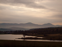 The view of the Mátra mountain range and a reservoir by Vizslás