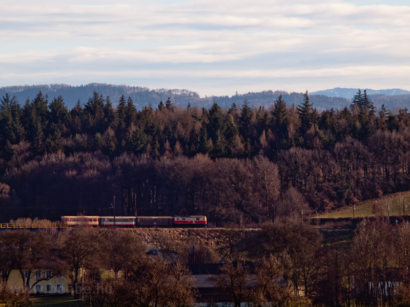 A passenger train hauled by a class 1099 electric locomotive seen between Schwadorf and Ober Grafendorf photo