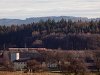 A passenger train hauled by a class 1099 electric locomotive seen between Schwadorf and Ober Grafendorf