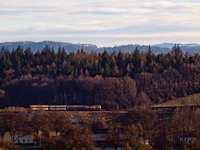 A passenger train hauled by a class 1099 electric locomotive seen between Schwadorf and Ober Grafendorf