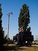 Old lamps, a class 424 steam locomotive and an old exit signal with three arms exhibited at Szolnok