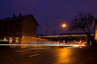 A CAF Urbos tram and a Stadler FLIRT EMU with streaking lights in a long exposure photograph at the former Kőbnya-Hzlal station