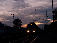A V43 is passing through Balatonfenyves station by sunset