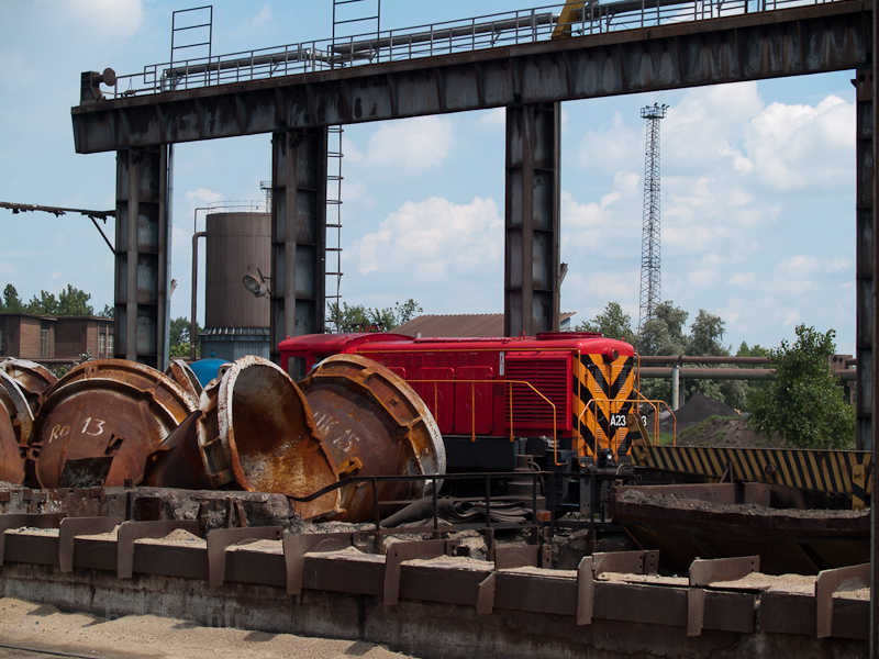 An A23 is shunting at Dunaferr with deformed slug carriers in the foreground photo