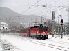 The BB 1044 122 is passing Payerbach-Reichenau station with a Sdbahn fast train in heavy snowfall