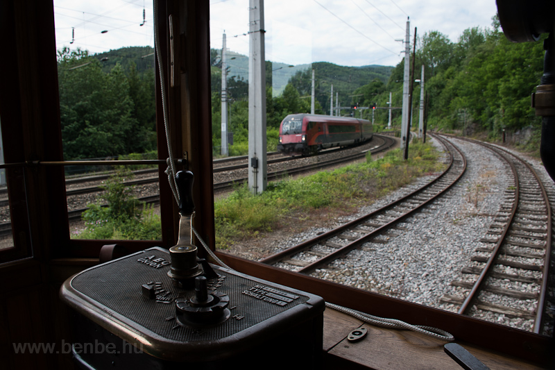 The Hllentalbahn TW 1 seen at Payerbach-Reichenau - the photo shows a railjet train bound for Vienna (Wien Hauptbahnhof) from the driver's cab of the narrow-gauge railcar photo