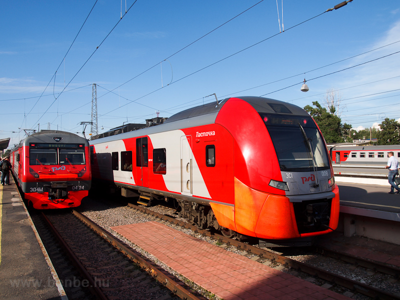 The RŽD ED4M 0424 and the ES1 008 Lastochka seen at St Petersburg Finlandyksy railway station photo