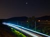 A FLIRT trainset at Biatorbgy station during a lunar eclipse