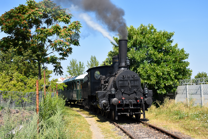 The MV Ia. 204 steam locomotive seen at -Szolnok with a historic train photo