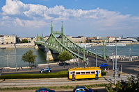 The BKV wood frame historic tram number 2806 is seen in its last operating condition and livery at Szent Gellrt tr with Szabadsg-hd (Liberty bridge), Corvinus Univeristy of Economics, the Duna (Danube) river and hotel boats in the background