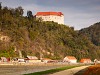 A Slovenian class 312 - 100 electric Desiro trainset seen between Brestanica and Blanca with Grad Rajhenburg castle in the background 