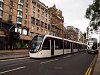 Tram and modern double-decker bus seen at Edinburgh