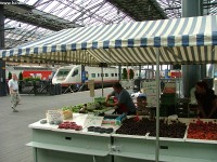 They are selling fruites nder the station roof