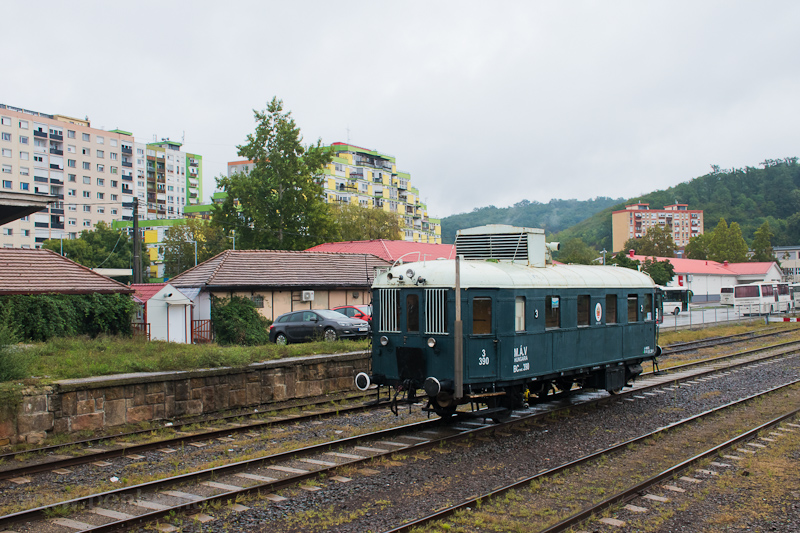 A MÁV-Rail Tours BCmot 390 Komló állomáson, a háttérben a híres Piramis-ház fotó