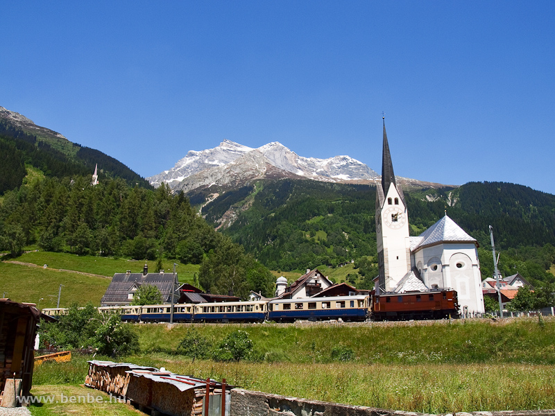 The RhB Ge 4/6 353 with the Alpine Classic Pullman Express at the classical photo site with the church at Trun photo