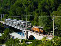 The RhB Ge 6/6<sup>I</sup> 414 Baby-Crodocile with a wooden frame historic consist between Trin and Reichenau-Tamins on the Vorderrhein bridge