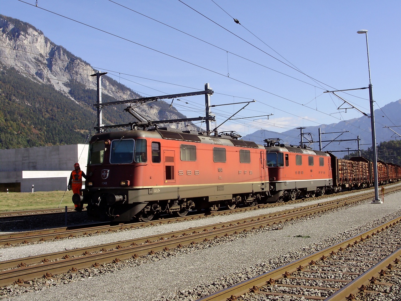 The SBB Re 420 11241 and its sister are hauling a normal-gauge freight train on the track plaite section of the RhB between Domat/Ems and Ems Werk photo