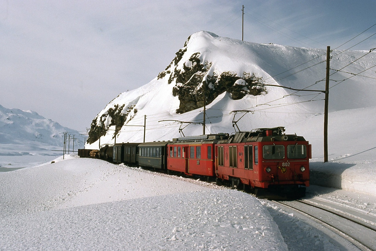 Az RhB Gem 4/4 802 plyaszm aggregtoros villanymozdonya egy ABe 4/4 II sorozat mororkocsival egy vegyesvonat ln Ospizio Bernina s Alp Grm kztt fot