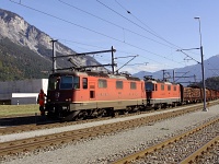 The SBB Re 420 11241 and its sister are hauling a normal-gauge freight train on the track plaite section of the RhB between Domat/Ems and Ems Werk