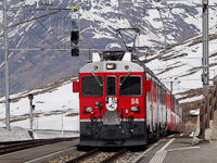 The ABe 4/4<sup>III</sup> 54 and 52 is seen hauling the Bernina-Express panoramic train at Ospizio Bernina