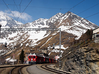 The ABe 4/4<sup>III</sup> 54 and 52 is seen hauling the Bernina-Express panoramic train at Alp Grm