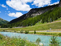 The Rhtische Bahn (RhB) Ge 4/6 353 and the Ge 6/6<sup>I</sup> 415 seen between La Punt-Chamues-ch and Madulain with the river Inn in the foreground