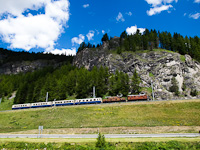 The Rhtische Bahn (RhB) Ge 4/6 353 and the Ge 6/6<sup>I</sup> 415 seen between La Punt-Chamues-ch and Madulain with Ruina da Guardaval in the background