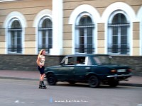 A girl waiting for costumers and her pimp in his Lada at Kolomiya