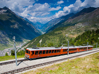 The Gornergratbahn (GGB) Bhe 4/8 3053 seen between Riffelalp and Riffelboden with the town of Zermatt visible in the valley below