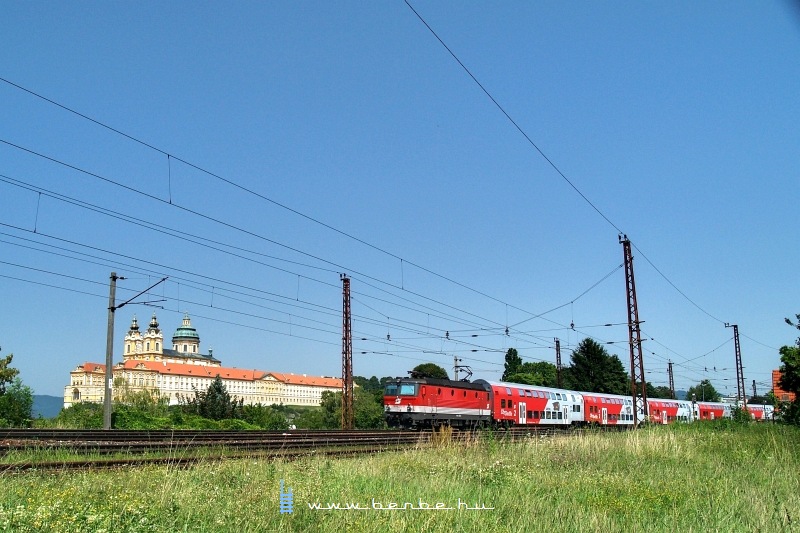 The 1144 272-0 is pushing a push-pull train near the Melk abbey photo