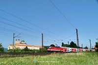 The 1144 272-0 is pushing a push-pull train near the Melk abbey